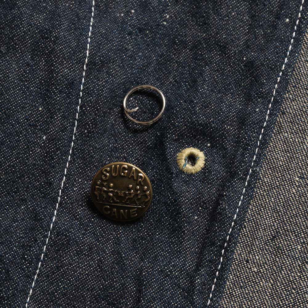 Close view of a removable change button and retaining ring on the Sugar Cane coat.