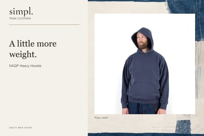 NAQP’s navy hoodie worn with the hood up, showing its roomy fit.
